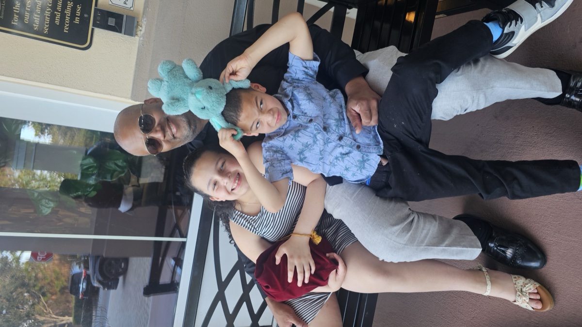 Gary with his kids on a sunny day